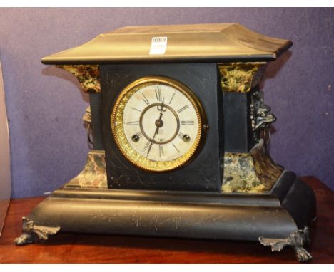 A late Victorian ebonised wood mantle clock, possibly by Ansonia, with lion mask handles and faux marble decoration, 33cm hig