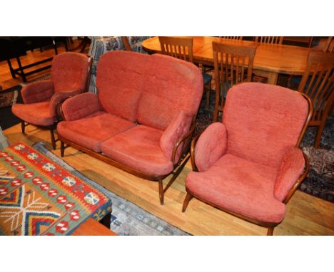 An Ercol three piece Windsor suite, comprising of two arm chairs and sofa, each with loose cushioned seat and back, 144cm wid