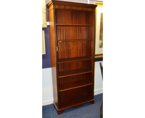 A Georgian style mahogany finished open book case, the projected moulded and dentil cornice over five adjustable shelves, slo