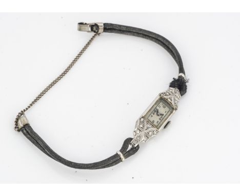 An Art Deco platinum and diamond lady's cocktail dress wristwatch, 12mm wide and 35 mm high, on leather strap 