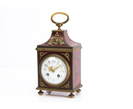 A late 19th century tortoiseshell and brass mantle clock, 28cm high with handle raised, pretty white enamel dial with floral 