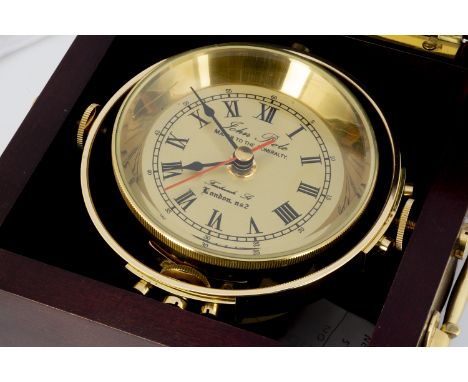 A modern ship's brass clock from John Poole, the gimble mounted quartz clock in wooden presentation hinged lidded box, 18cm w