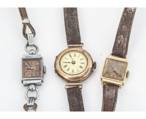 Two first half 20th century gold cased lady's wristwatches and another, one square example in 18ct, the other trench style in