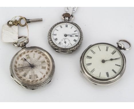 Three late 19th century continental white metal ladies open faced pocket watches, one with engraved silvered dial, and two wh