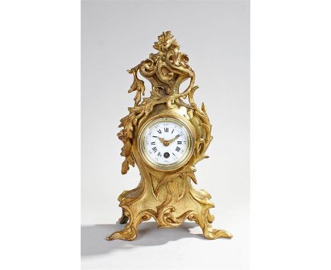 Late 19th Century French gilt metal clock, surmounted by a foliate basket above leaf decoration and scroll feet, the white en