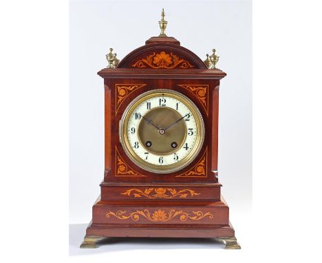 Early 20th Century mahogany and inlaid bracket clock, the arched top above an inlaid case and step base to brass ogee feet, t