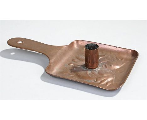 Newlyn copper chamber stick, decorated with a pair of fish facing the stick, with a flat handle, 26cm long