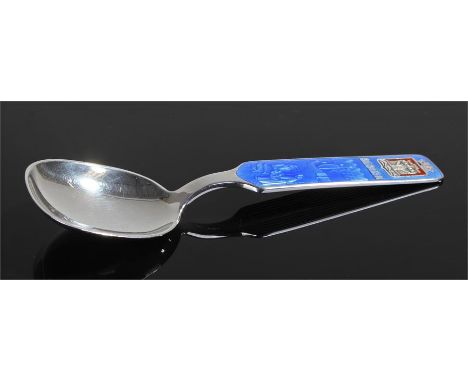 Norwegian sterling silver and guilloche enamel spoon, the spoon decorated with blue enamel with a shipping and fish stall sce