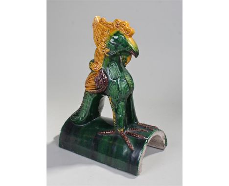 Decorative Oriental pottery ridge tile, in the form of a bird decorated with greens, yellow and brown, 35cm high