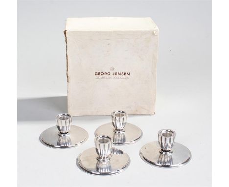 Designed by Harald Nielsen for Georg Jensen, a set of four Danish silver taper sticks, import marks, stamped to the base Geor