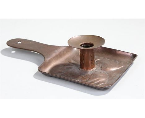 Newlyn copper chamber stick, decorated with a pair of fish facing the stick, with a flat handle, 26cm long