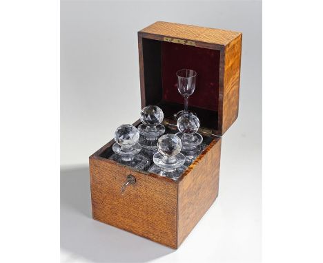 Victorian oak decanter box containing four decanters with a single glass held in the lid. 22cm wide  26cm high 22cm deep