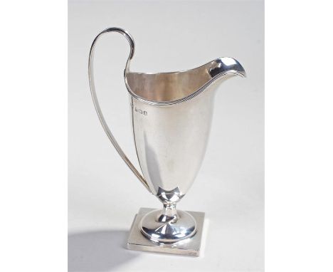 George V silver helmet jug, Birmingham 1915, makers mark rubbed, of typical form with a long body and handle raised on a squa