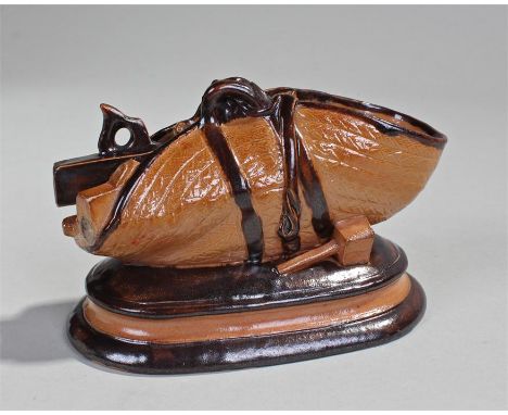 George Tinworth for Doulton Lambeth stoneware model of a carpenters toolbag, the open bag with a plane to one end, a saw insi
