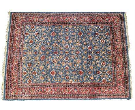 Persian carpet, with a blue ground and red flowers, the surround with a row of borders with flowers, 400cm x 295cm