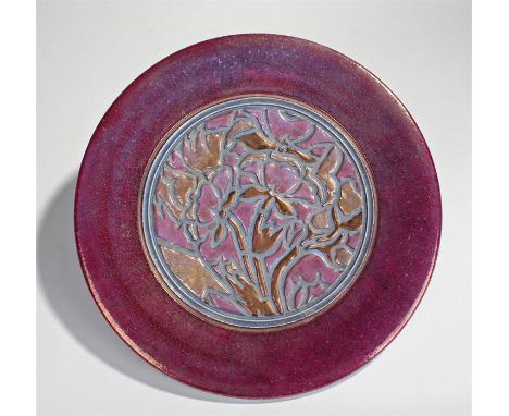 Sir Edmund Elton pottery charger, with a deep red surround and stylised foliate decoration to the centre, crackle glaze to th