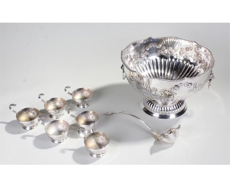 Silver plated punch bowl and cups, the wavy edge punch bowl with foliate decoration on a gadrooned base, together with six cu