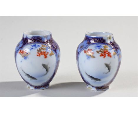 Japanese miniature Fukagawa porcelain miniature pair of vases, decorated with koi carp swimming to the white ground, blue gil