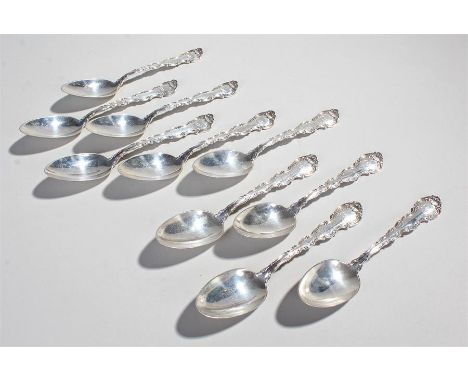 Set of ten Sterling silver dessert spoons, with scroll handles and shell capped bowls, 9.9oz, (10)