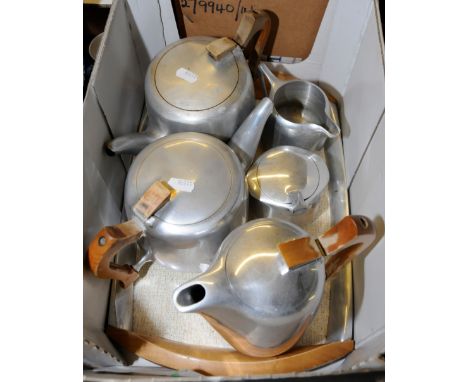 Three piece pique ware tea service on tray with additional teapot 
