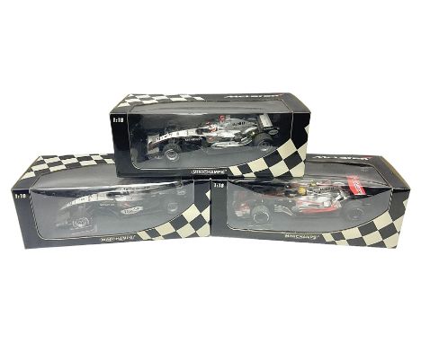 Three Minichamps 1:18 scale die-cast McLaren racing cars - Mercedes MP4-19 D. Coulthard; Mercedes MP4-20 K. Raikkonen; and Vo