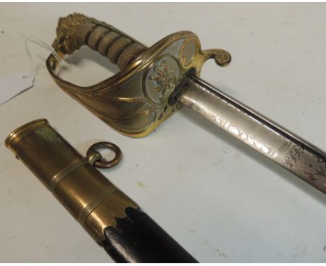 A Royal Naval officers sword by Firmin, London, having gilt brass lion head pommel, wire bound shagreen grip, blade etched wi