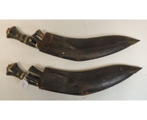 Two early 20th Century Kukri each in leather scabbard and with two smaller knives (2)