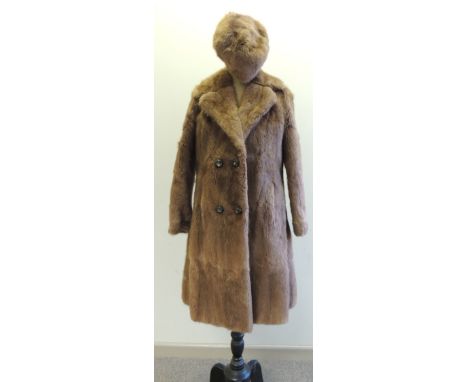 A ladies light mink fur coat, double breasted together with a matching hat; the coat labelled Churchill Furs Rustington West 
