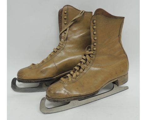 A pair of early 20th Century ladies ice skating boots in light brown leather on Pinnacle blades