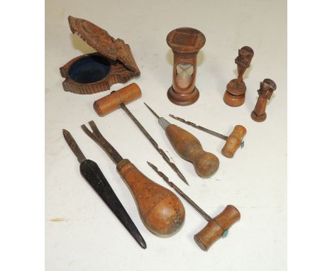 Treen - a carved wood travelling watch stand; an egg timer; two small carved wood figures; some wood working tools and a flea