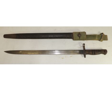 A WWI period Remington bayonet with wood grip, straight deeply fullered blade dated 1913 and in original leather covered scab