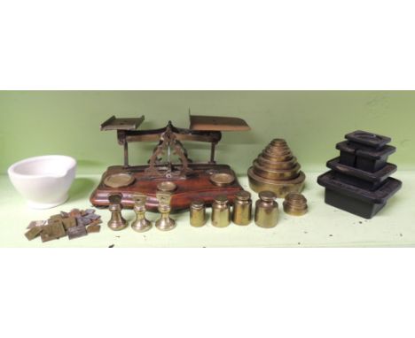 A small white stoneware mortar; collection of apothecary's weights; set of domestic postal scales; set of brass Avery stackin