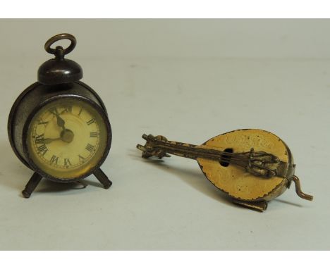 Two novelty tape measures - one modelled as an alarm clock the other a mandolin, height of clock 4.5cms (2)