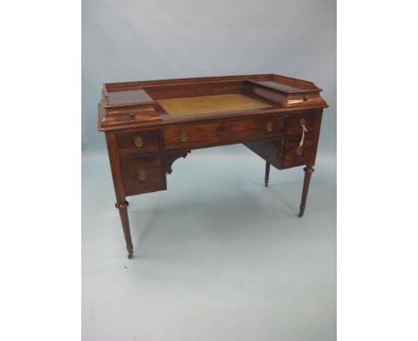 An early 20th century inlaid mahogany kneehole desk, inset leather top with two shallow drawers, arrangement of five drawers 