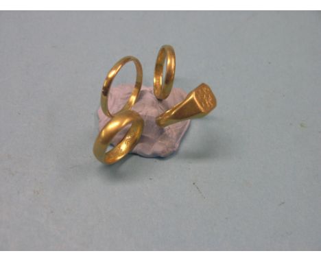 Three 22ct. gold band wedding rings, and a 22ct. gold signet ring, 19.1 grams total