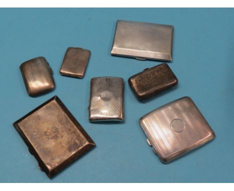 An engine-turned silver cigarette case, Birmingham 1932, five other silver cigarette cases and an engine-turned silver vesta 