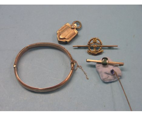 A 9ct. engraved gold bangle, 7.9 grams, together with a 9ct. gold Middlesex Regiment bar brooch, amethyst stick pin, engraved