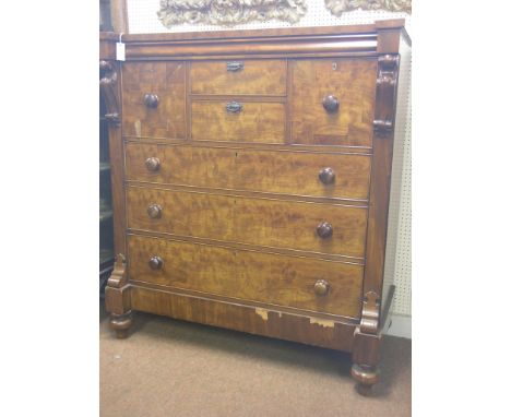 A large Victorian mahogany chest, unusual configuration of four short and three long drawers, carved corbels, on turned feet,