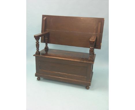 A solid, dark oak monk's bench, on panelled box base, 3ft. 7in.