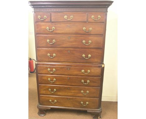 A large George III mahogany chest on chest, blind-fret frieze above three short and seven long graduated drawers, each oak-li