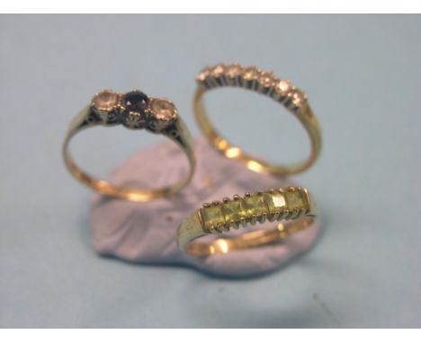 An 18ct. gold ring, set seven small diamonds, a 9ct. gold ring set central blue stone and two clear stones, and a 9ct. gold r