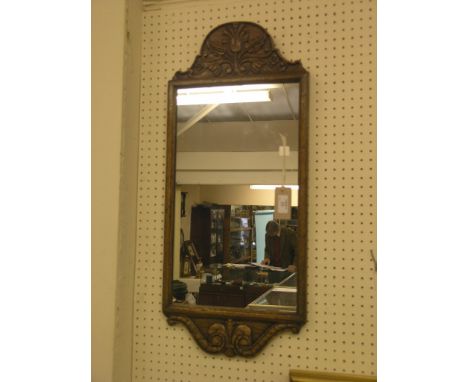 A solid, dark oak mirror, floral-carved in Jacobean style, plate 20 x 11in. 