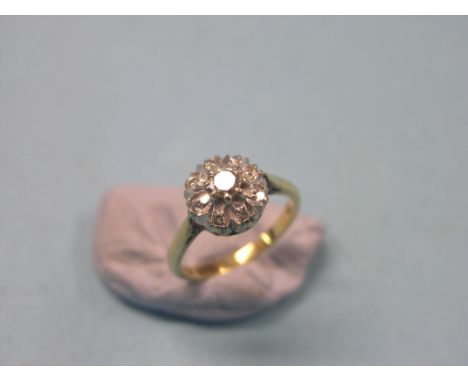 An 18ct. gold and diamond cluster ring, rosette design with claw settings, size L