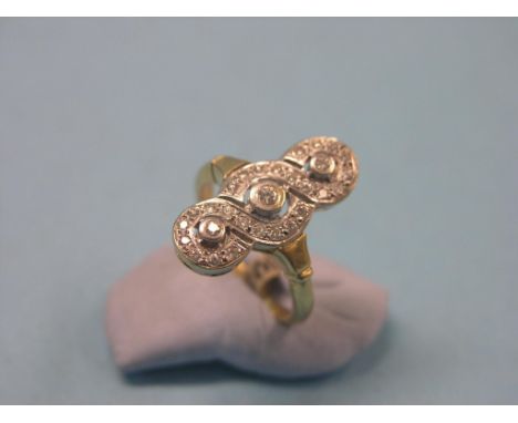 An 18ct. gold and diamond cluster ring, guilloche design