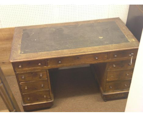 A Victorian oak desk, three frieze drawers, three further drawers to each pedestal, on casters, as viewed