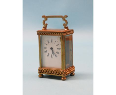 A French brass carriage clock, with enamelled dial and timepiece movement, case with guilloche borders, 6in.