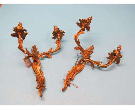 A pair of French rococo-style ormolu wall lights, each twin-light, leaf-cast, 16in. high