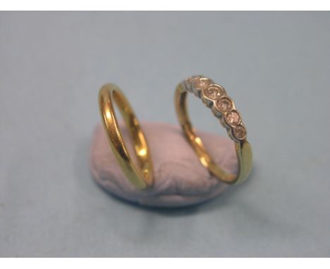 An 18ct. gold half-hoop ring, set seven graduated diamonds, and a 22ct. gold band wedding ring, 4.7 grams