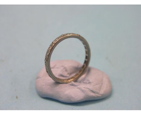 An engraved white metal and diamond full eternity ring, numerous small diamonds, unmarked, size S
