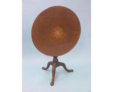 A George III mahogany tilt-top tripod table, circular top inlaid with a floral roundel in boxwood and holly, stem with carved